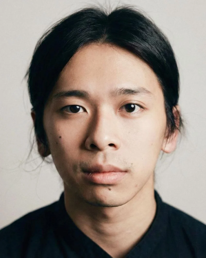 Aston Ng, founder and head educator at The Cave, with long dark hair tied back and light stubble