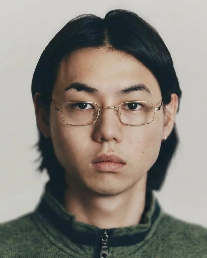 Haydn Yu, social media executive at The Cave, with medium-length hair and thin wire-frame glasses